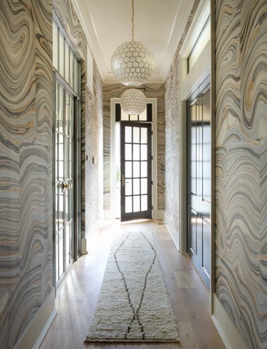 Hallway Wallpaper Ideas in foyer hallway with statement pink and gray agate pattern wallpaper