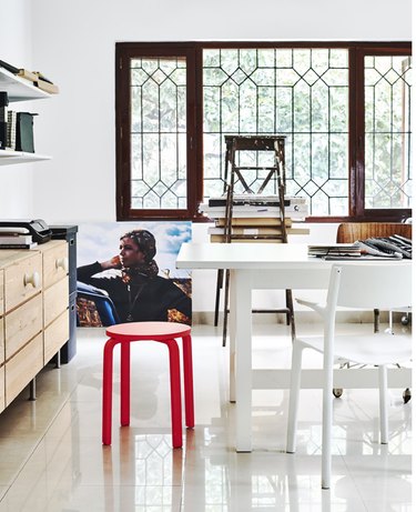 Scandinavian home office with white desk and red stool