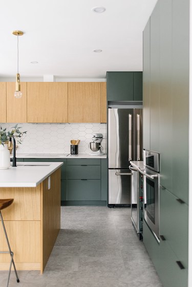 Modern cookspace with green and wood flat panel kitchen cabinets