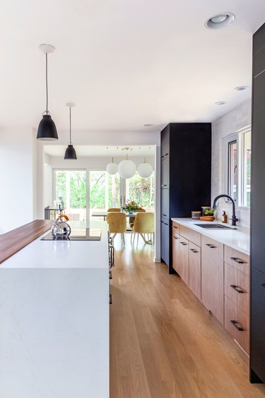 Modern cookspace with wood flat panel kitchen cabinets and white island