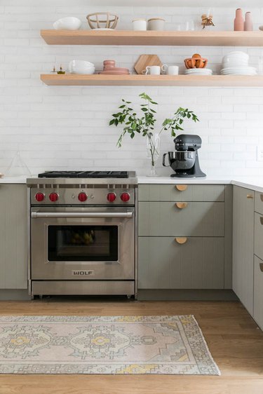 Modern cookspace with green beadboard flat panel kitchen cabinets