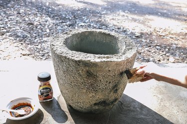 Applying coffee mixture to hypertufa planter with a sponge