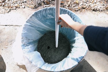 Pressing PVC pipe into hypertufa mix that has been packed into bottom of mold