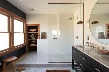 traditional shower fixtures in bathroom with large walk-in shower and wood trim