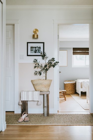 Hallway Makeover Ideas in two tone hallway with molding, wall lights and jute runner