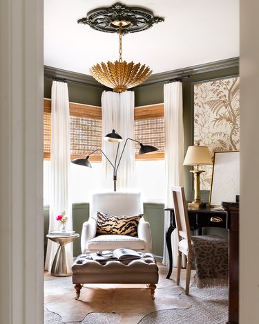 Green home office with animal print touches and brass finishes