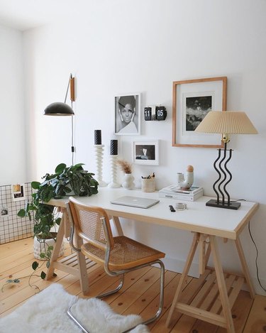 office space decor including frames, candles, lamps, and plants