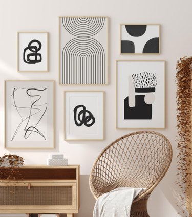Hallway Gallery Wall Ideas with prints, art, wicker chair, credenza, blanket.