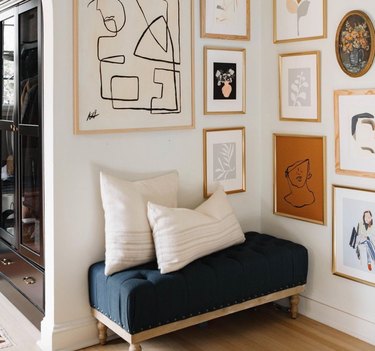 Hallway Gallery Wall Ideas with prints, art, bench, cushions.