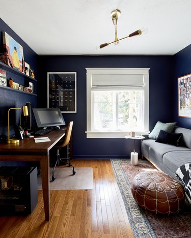 blue home office with midcentury decor and moroccan pouf