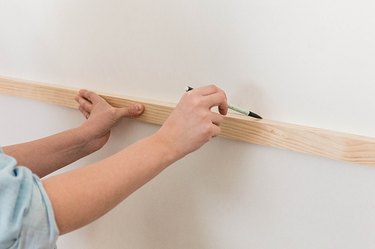 Make a pencil mark along the top edge of the horizontal slat.