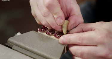 the repair shop jewelry restorer repairs a family heirloom garnet bracelete
