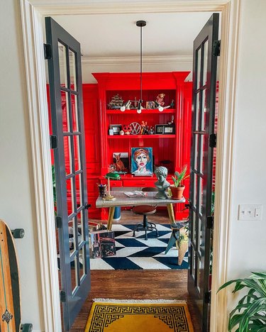 Sarisa Munoz The Indigo Leopard Home office with black and white floor tile and red cabinetry
