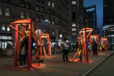 photo of architectural project with people underneath read structures in a cityscape