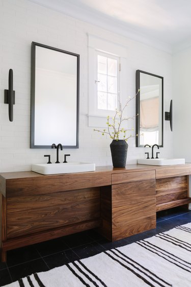 Bathroom Trends 2021 white bathroom with wooden vanity and black taps