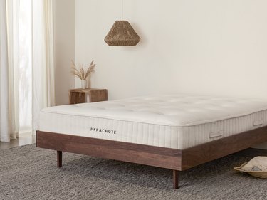 bare mattress on dark wood bedframe