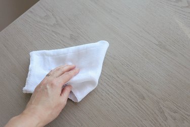 Wiping desk clean with cotton cloth