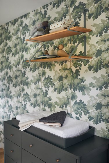 Stuffed Animal Storage in Nursery with hanging shelves and wallpaper designed by Prospect Refuge Studio