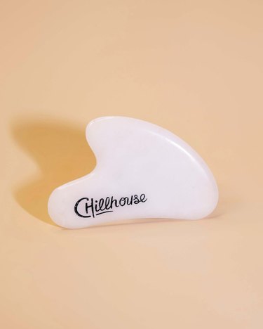 facial massage tool with "chillhouse" logo