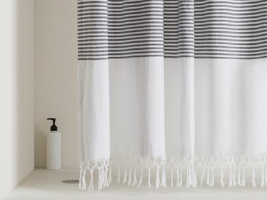 Turkish eco-friendly shower curtain with gray stripes and hand-knotted fringe