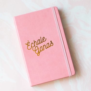 pink notebook with phrase "échale ganas"