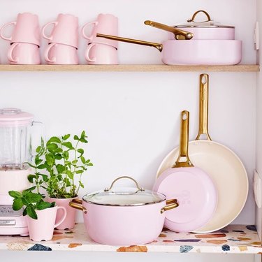 Pale pink and brass cookware set