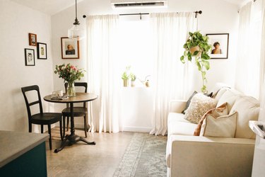 garage bedroom idea with sleeper sofa and dining table