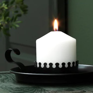 white candle in black holder
