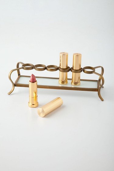 Makeup Organizer Ideas with Brass lipstick holder with glass tray.