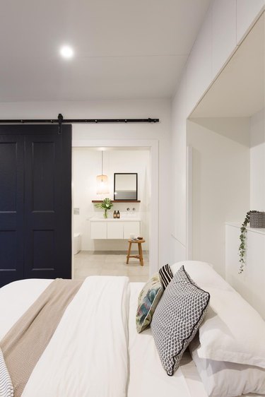 black and white converted garage bedroom idea with barn door