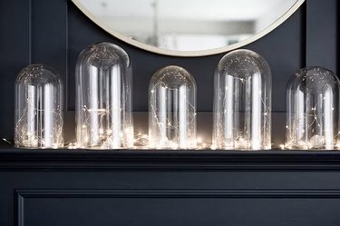 Create a Warm Holiday Display Using Glass Cloches and Lights