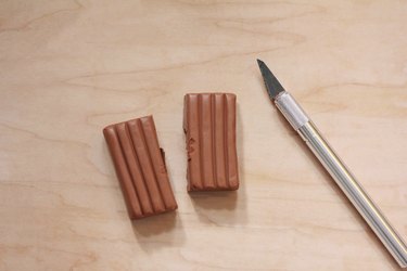 Terra cotta clay cut into two pieces with a craft knife