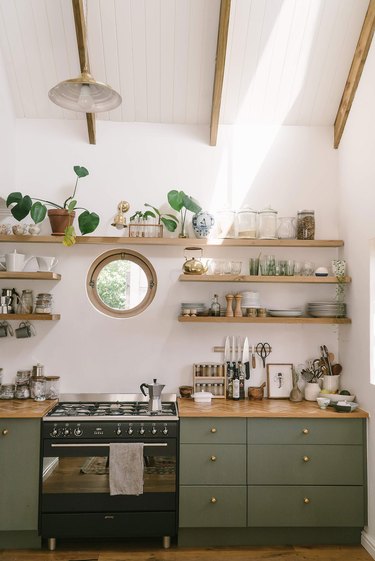 white and sage green kitchen with gas stovetop