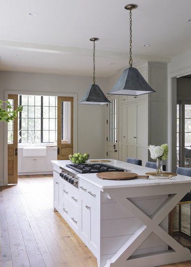 Farmhouse style kitchen with an island stovetop designed by Rachel Halvorson.