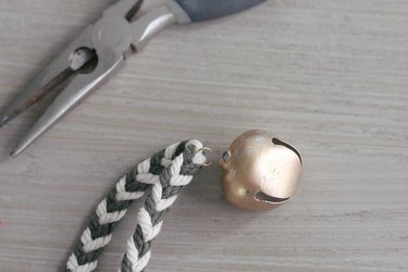 Attaching brass bell to garland with jump ring