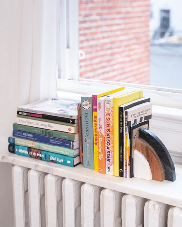 book storage ideas with a marble shelf on top of a radiator makes a small bookshelf.