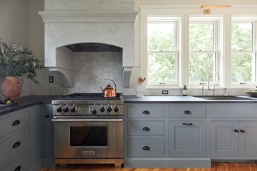 Kitchen with blue cabinets and Wolf oven and stove designed by Prospect Refuge Studio eco-friendly stove oven
