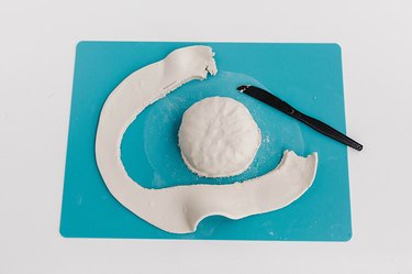 Trim off the excess clay from the flattened shape.