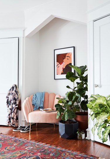 sitting area with blush lounge chair and potted plants