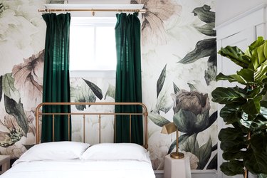 bedroom with floral wallpaper and green drapery