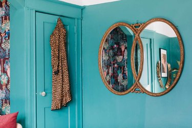 green walls with framed mirror