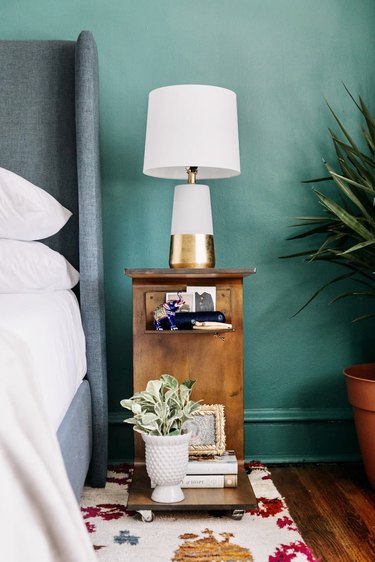 bedroom with green walls and upholstered bed