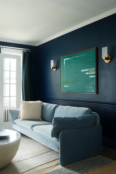 living room with blue walls and light blue sofa