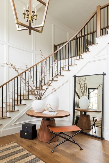 White, wood and gold entryway designed by Studio McGee with Contemporary Foyer Lighting