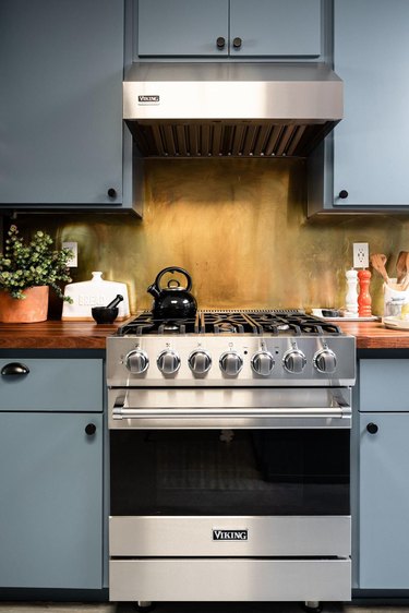 blue kitchen with contemporary gas new stove