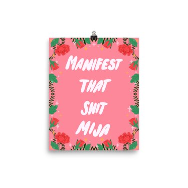 print with pink background and roses with phrase that reads "manifest that shit mija"