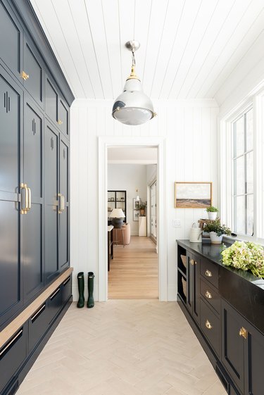 mudroom storage with moody black cabinets