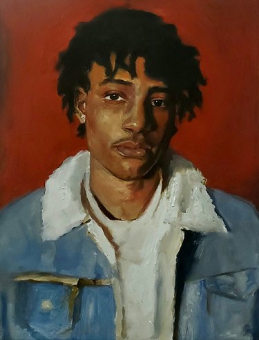 Painted portrait of a young man with short dreadlocks, wearing a white T-shirt and blue jean jacket, against red wall