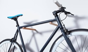 bike storage using wooden pegs mounted on the wall