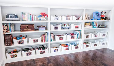 Toy storage on simple white shelves